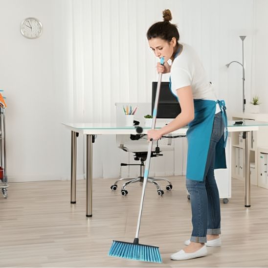 Femme nettoie chambre avec balai bleu