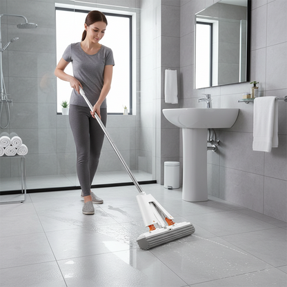 Femme nettoie avec le balai à laver le sol dans la salle de bain