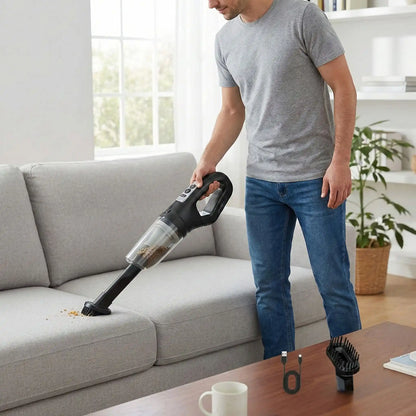 homme nettoie avec mini aspirateur sans fil son canapé